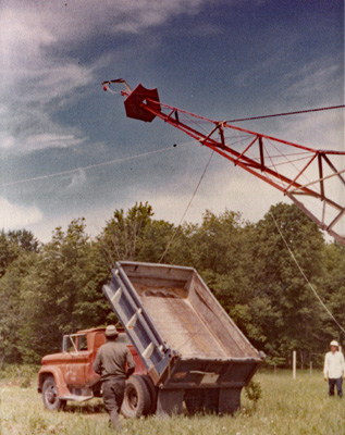 raising windmill tower with dumptruck